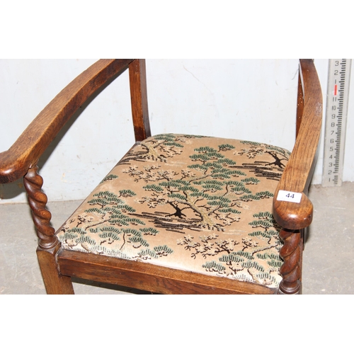 44 - An Art Deco period oak framed low armchair with barleytwist supports