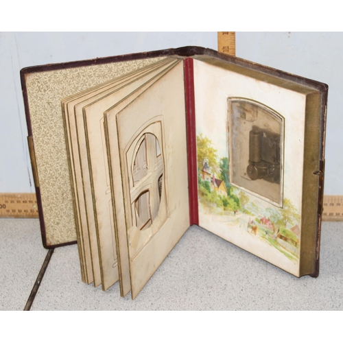 500 - 2 Victorian leather bound photograph albums with musical movements, also containing some photographs