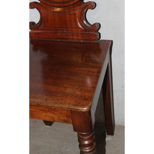 78 - A 19th century mahogany hall chair with circular back