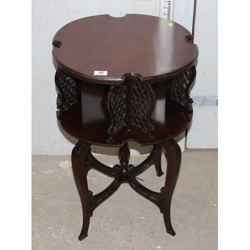 86 - An antique style mahogany revolving bookcase table with fretwork panels