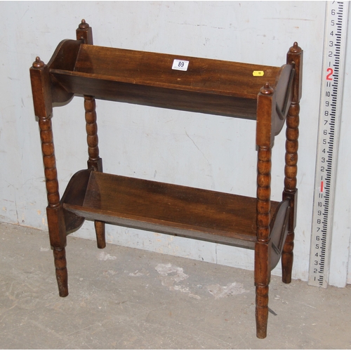 89 - An early 20th century wooden book trough with bobbin turned legs, approx 56cm wide