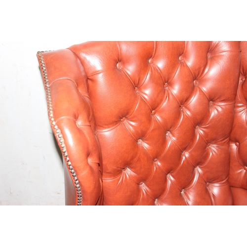 93 - Vintage red leather effect winged backed arm chair