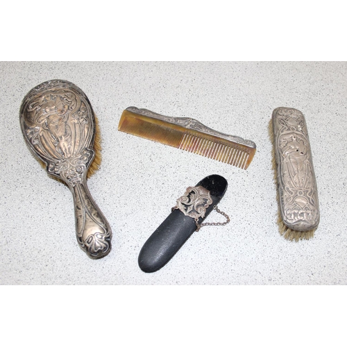 1003 - A silver mounted hand mirror, 2 silver mounted Art Nouveau brushes and a silver mounted comb, Birmin... 