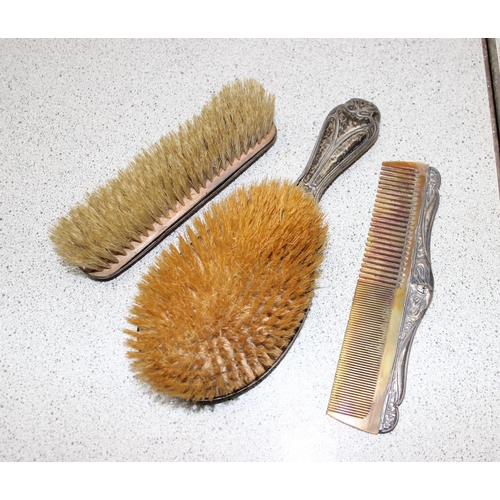 1003 - A silver mounted hand mirror, 2 silver mounted Art Nouveau brushes and a silver mounted comb, Birmin... 