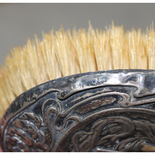 1003 - A silver mounted hand mirror, 2 silver mounted Art Nouveau brushes and a silver mounted comb, Birmin... 