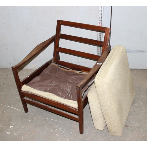 113 - A Scandinavian style retro teak framed armchair with cushions, seemingly unmarked