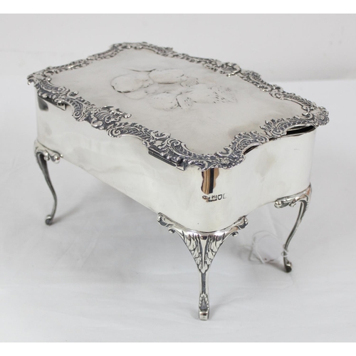 1027 - An impressive large silver jewellery casket with embossed Reynold's Angels decoration and scrolled e... 