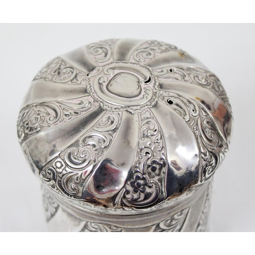 1029 - A silver tea caddy or tobacco pot with swirled design and embossed decoration, Birmingham 1892, make... 