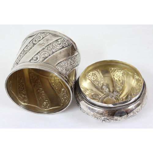 1029 - A silver tea caddy or tobacco pot with swirled design and embossed decoration, Birmingham 1892, make... 