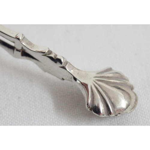 1038 - A pair of silver sugar tongs, likely 18th century, marked IG, no town or date letter