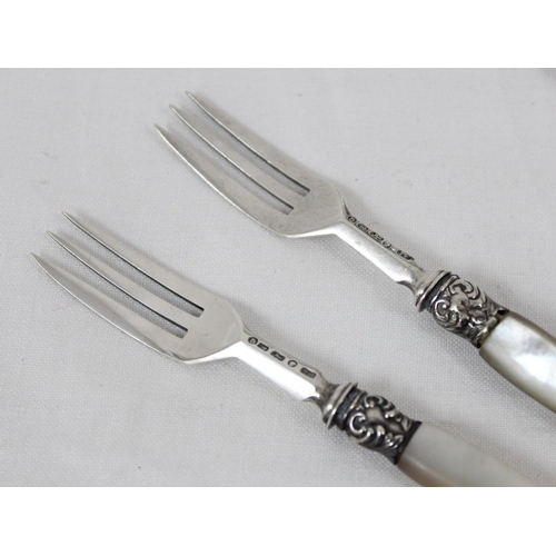 1040 - A pair of silver pickle forks with mother of pearl handles, Birmingham 1876 by John Gough, 2 silver ... 