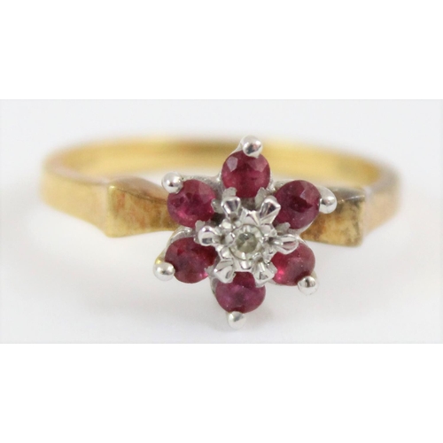 1102 - 18ct gold floral set ring with a central diamond surrounded by 6 rubies, London 1976, approx size N,... 