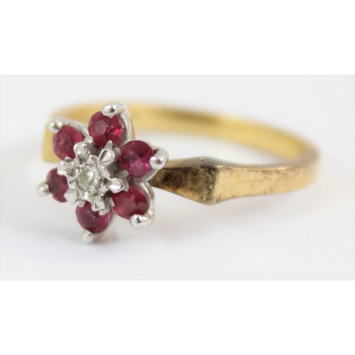 1102 - 18ct gold floral set ring with a central diamond surrounded by 6 rubies, London 1976, approx size N,... 