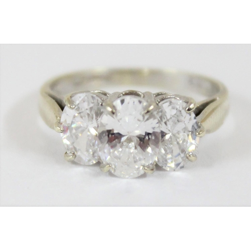 1144 - A 9ct white gold ring containing 3 large white stones, approx size N, approx 3.39g gross