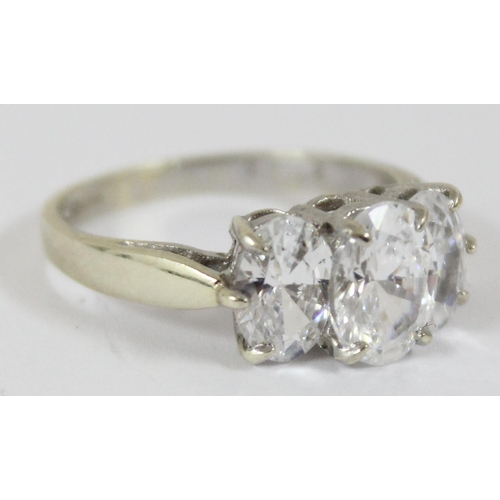 1144 - A 9ct white gold ring containing 3 large white stones, approx size N, approx 3.39g gross