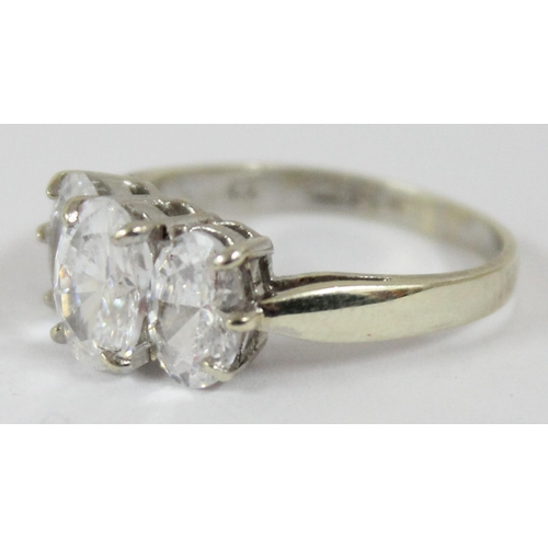 1144 - A 9ct white gold ring containing 3 large white stones, approx size N, approx 3.39g gross