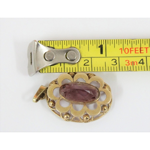 1147 - A 9ct gold mounted pendant set with purple stone, hallmarks indistinct but XRF tested as 9ct gold, a... 