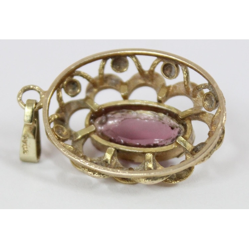 1147 - A 9ct gold mounted pendant set with purple stone, hallmarks indistinct but XRF tested as 9ct gold, a... 