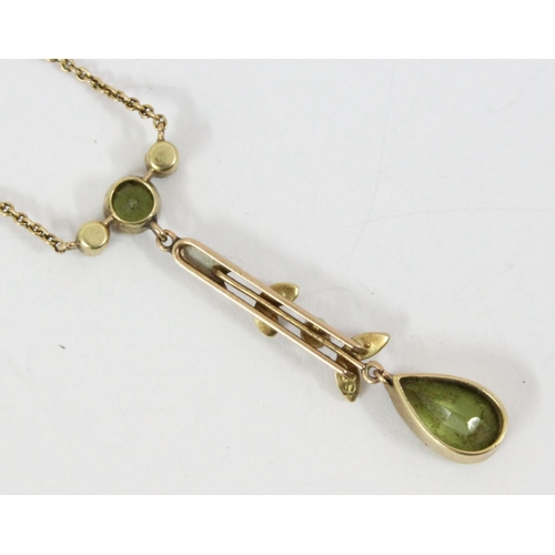 1162 - An Edwardian 15ct gold Art Nouveau pendant set with seed pearls and peridot, on 15ct gold chain, app... 