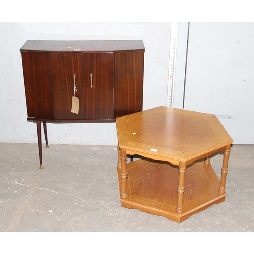 129 - Mid-century polished bi-folding door cupboard on legs with a light oak legate coffee table (2)