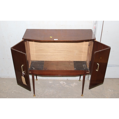 129 - Mid-century polished bi-folding door cupboard on legs with a light oak legate coffee table (2)