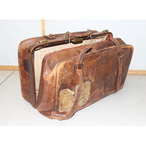 206 - A large early 20th century leather travelling case or luggage bag with labels