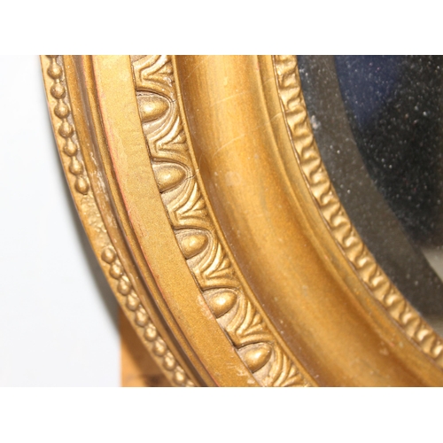 423 - A vintage oval gilt framed wall mirror