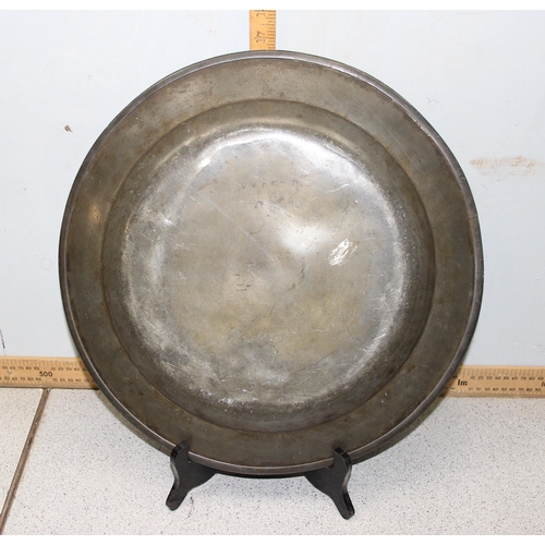 1047 - A large antique pewter charger, 19th century or earlier, approx 42cm in diameter, some impressed mar... 