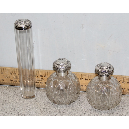 1034 - A pair of silver topped grenade shaped perfume bottles, Birmingham 1892 by Arthur Willmore Penningto... 