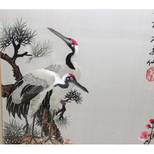 442 - A pair of vintage Japanese embroidered panels of cranes, both bearing signatures, each approx 67cm x... 