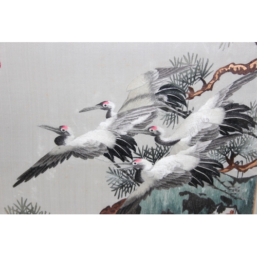 442 - A pair of vintage Japanese embroidered panels of cranes, both bearing signatures, each approx 67cm x... 