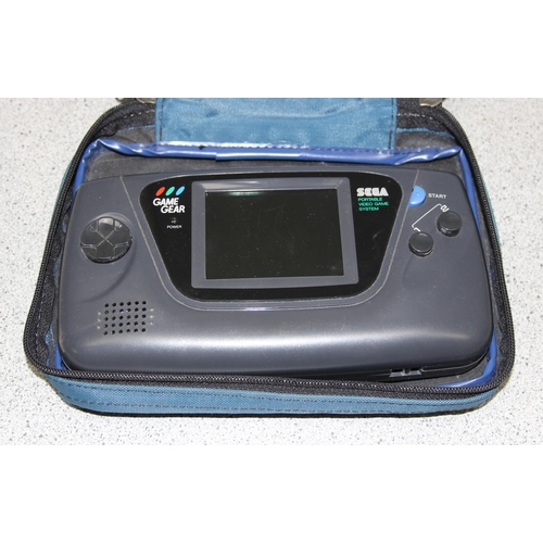 1535 - Sega game gear hand held games console with TV tuner, magnifier, and battery charger