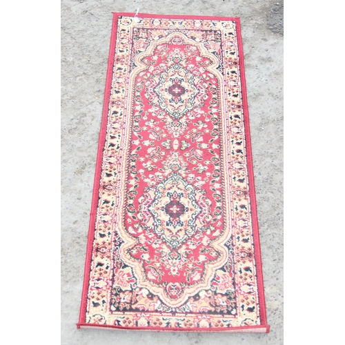 205 - A modern red runner rug, approx 200cm x 70cm