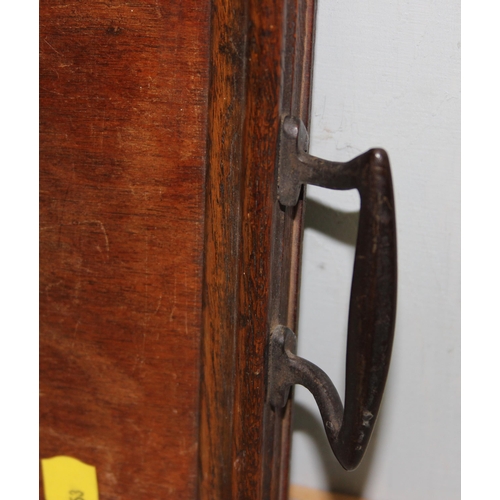 299 - An early 20th century Art Nouveau wooden serving tray with brass handles, approx 58cm wide