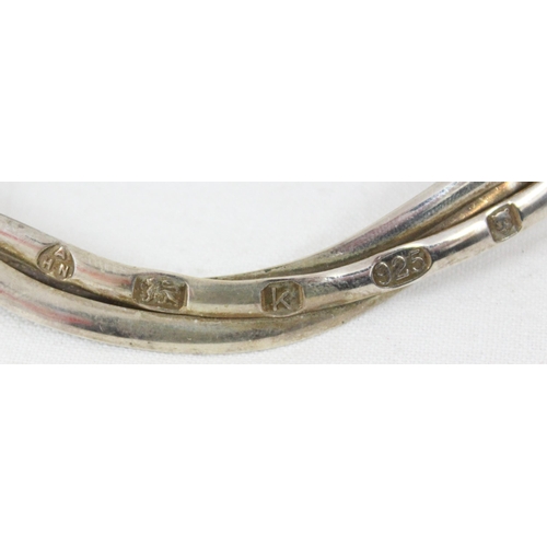 1179 - A contemporary Haviland silver necklet formed from three interwoven bands, marked for London 2009 by... 