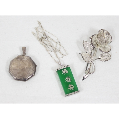 1180 - A Chinese silver and jade pendant, a silver octagonal locket and a silver flower brooch (3)