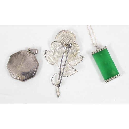 1180 - A Chinese silver and jade pendant, a silver octagonal locket and a silver flower brooch (3)