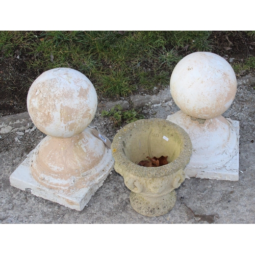 333 - A pair of spherical concrete post finials and a concrete garden urn of classical form