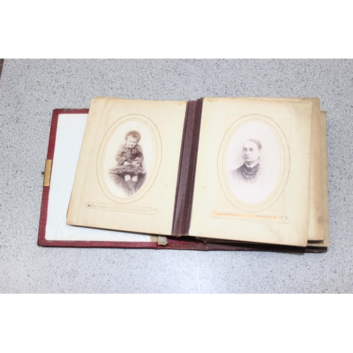 563 - A 19th century leather bound photograph album and photographs,