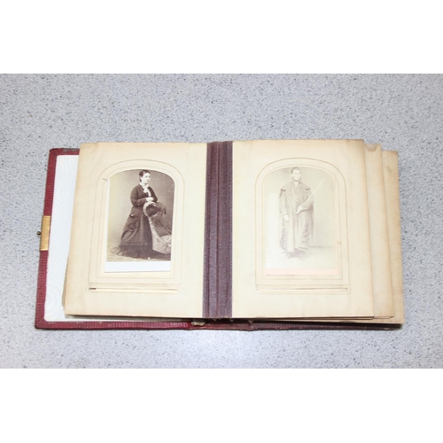 563 - A 19th century leather bound photograph album and photographs,