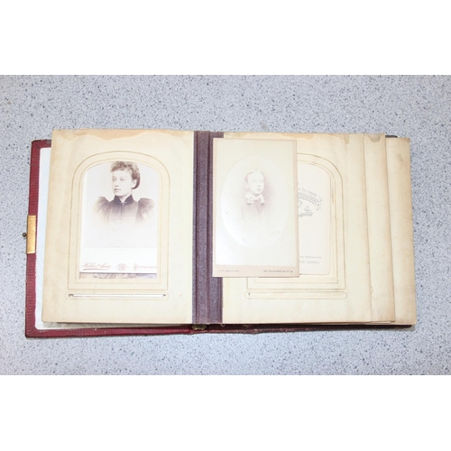 563 - A 19th century leather bound photograph album and photographs,