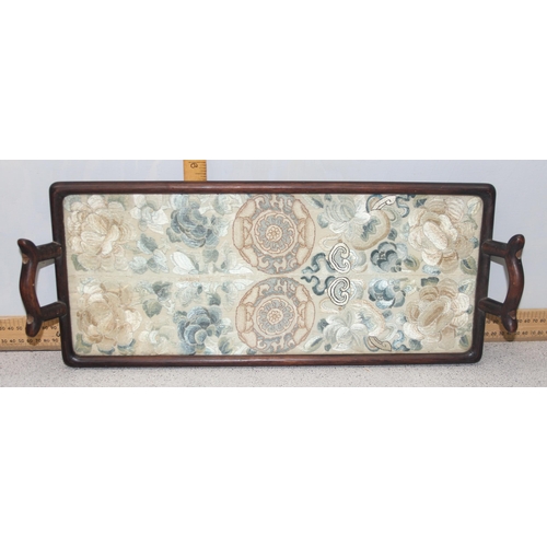 302 - A pair of antique Chinese silk embroidered sleeve bands later mounted in a hardwood tray frame, appr... 