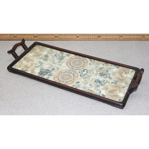 302 - A pair of antique Chinese silk embroidered sleeve bands later mounted in a hardwood tray frame, appr... 