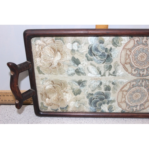 302 - A pair of antique Chinese silk embroidered sleeve bands later mounted in a hardwood tray frame, appr... 