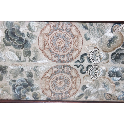 302 - A pair of antique Chinese silk embroidered sleeve bands later mounted in a hardwood tray frame, appr... 