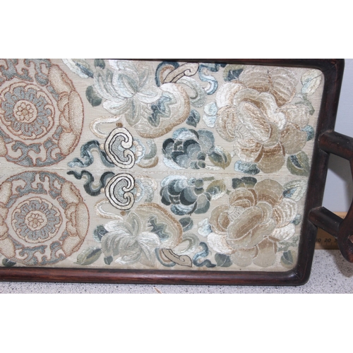 302 - A pair of antique Chinese silk embroidered sleeve bands later mounted in a hardwood tray frame, appr... 