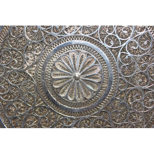 1061 - An intricate silver filigree circular dish, unmarked but XRF tested as approximately 95% pure, appro... 