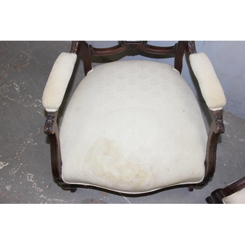 27 - A pair of Victorian armchairs with carved details and stuffed seats and backs