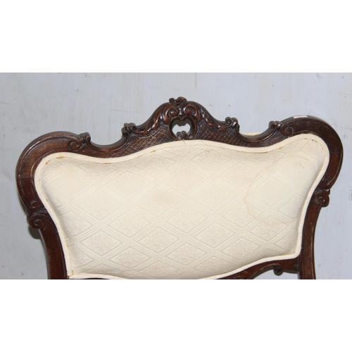 27 - A pair of Victorian armchairs with carved details and stuffed seats and backs