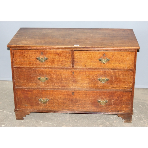 10 - An antique oak 2 over 2 chest of drawers with brass handles and bracket feet, approx 110cm wide